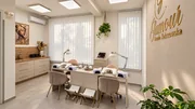 Stanowiska manicure z jasnymi meblami, złotym logo Glamour i zielenią.